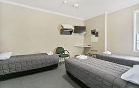 three single beds in the room with shared bathroom